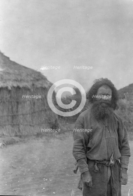 Ainu man standing outside, 1908. Creator: Arnold Genthe.