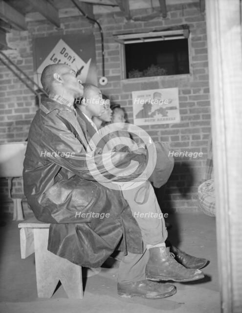 Air raid wardens attending a meeting in their headquarters, Washington, D.C., 1943. Creator: Gordon Parks.