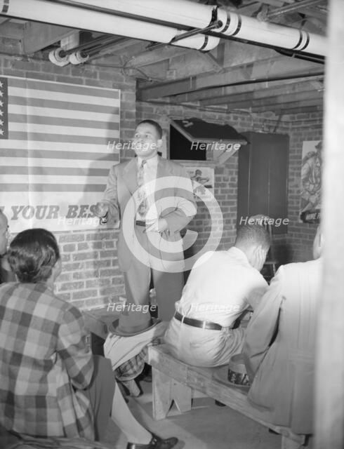Air raid wardens' meeting in zone nine, Southwest area, Washington, D.C, 1942. Creator: Gordon Parks.