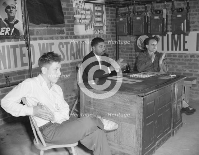 Air raid wardens' meeting in zone nine, Southwest area, Washington, D.C, 1942. Creator: Gordon Parks.