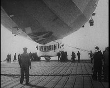 Airship Approaching an Aircraft Carrier And Attempting To Land, 1920s. Creator: British Pathe Ltd