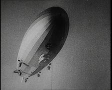 Airship Approaching an Aircraft Carrier And Attempting To Land, 1920s. Creator: British Pathe Ltd