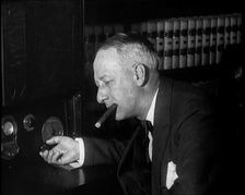 Al Smith, Former Presidential Candidate, Smoking a Cigar And Following Election Results..., 1932. Creator: British Pathe Ltd