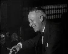 Al Smith, Former Presidential Candidate, Smoking a Cigar And Following Election Results..., 1932. Creator: British Pathe Ltd