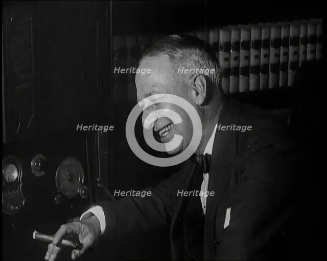 Al Smith, Former Presidential Candidate, Smoking a Cigar And Following Election Results..., 1932. Creator: British Pathe Ltd.
