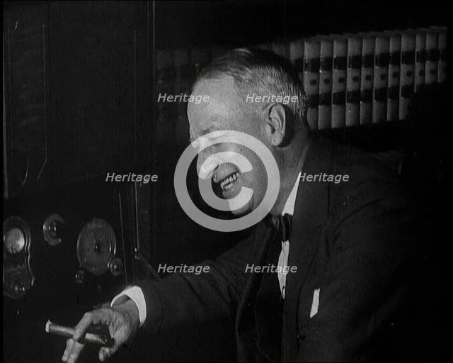 Al Smith, Former Presidential Candidate, Smoking a Cigar And Following Election Results..., 1932. Creator: British Pathe Ltd.