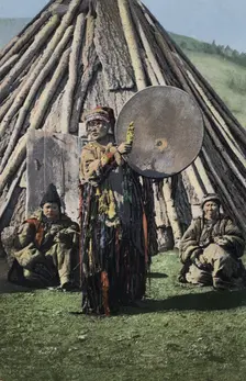 Altai Shaman with Tambourine in Front of a Traditional Dwelling (Chaadyr), 1911-1913. Creator: Sergei Ivanovich Borisov