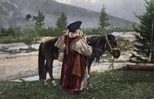 Altai Woman in National Costume (Hat: Kuaraan Boruk, Sheepskin Coat: Ton, Sleeveless..., 1911-1913. Creator: Sergei Ivanovich Borisov