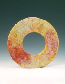 Altered jade bi-disc with russet patches, Neolithic, Liangzhu culture, China, c3400-c2250 BC. Creator: Unknown