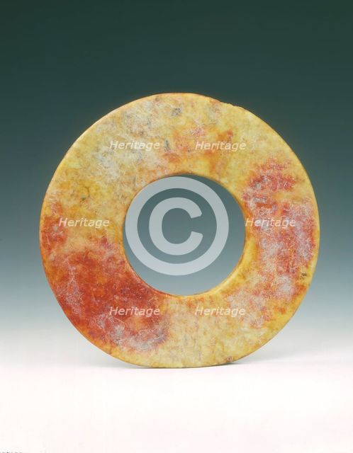 Altered jade bi-disc with russet patches, Neolithic, Liangzhu culture, China, c3400-c2250 BC. Creator: Unknown.
