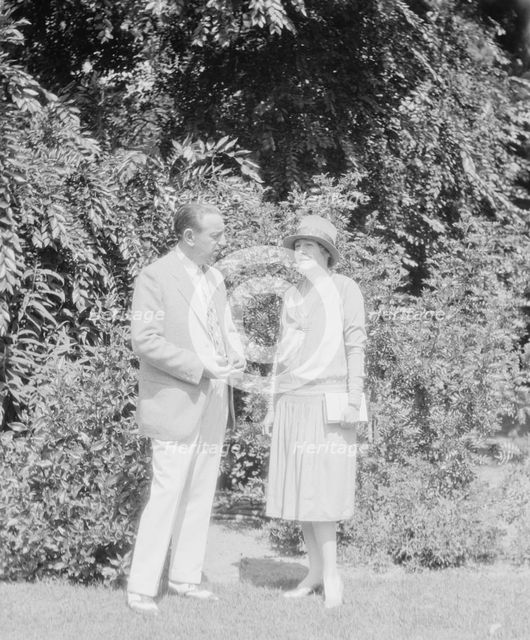 Alanson, Bertram, Mr. and Mrs., standing outdoors, between 1927 and 1937. Creator: Arnold Genthe.