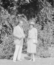Alanson, Bertram, Mr. and Mrs., standing outdoors, between 1927 and 1937. Creator: Arnold Genthe