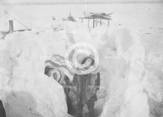 Alaskan Eskimos with their winter home half underground in village of Stebbins, c1900- c1930. Creator: Unknown.