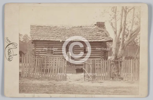 Albumen print of a woman and two children in front of a log house in Georgia, 1880s. Creator: H. S. Clark.