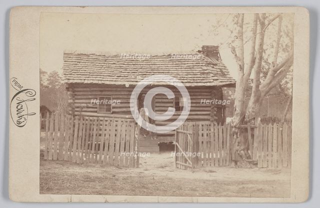 Albumen print of a woman and two children in front of a log house in Georgia, 1880s. Creator: H. S. Clark.