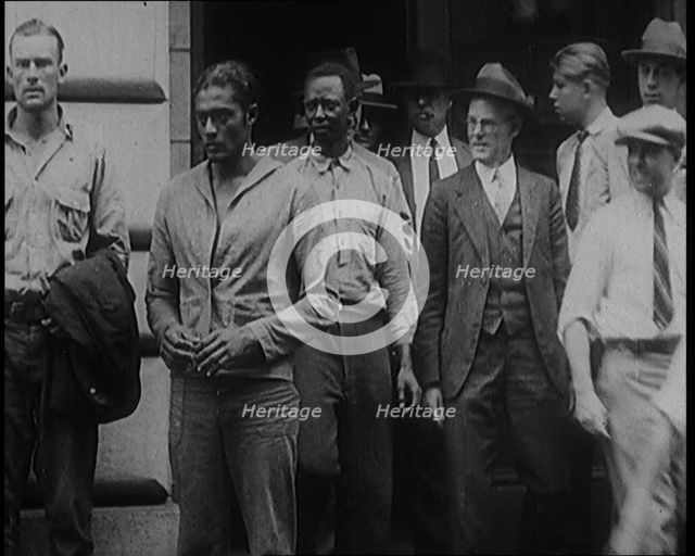 Alcohol Smugglers Coming Out of Court, 1929. Creator: British Pathe Ltd.