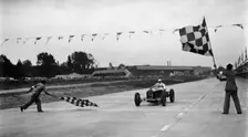Alfa Romeo taking the chequred flag in a race at Brooklands. Artist: Bill Brunell