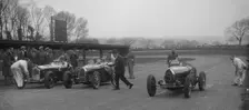 Alfa Romeo and two Bugatti Type 35s on the start line, Donington Park, Leicestershire, 1935. Artist: Bill Brunell
