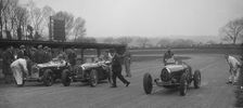 Alfa Romeo and two Bugatti Type 35s on the start line, Donington Park, Leicestershire, 1935. Artist: Bill Brunell