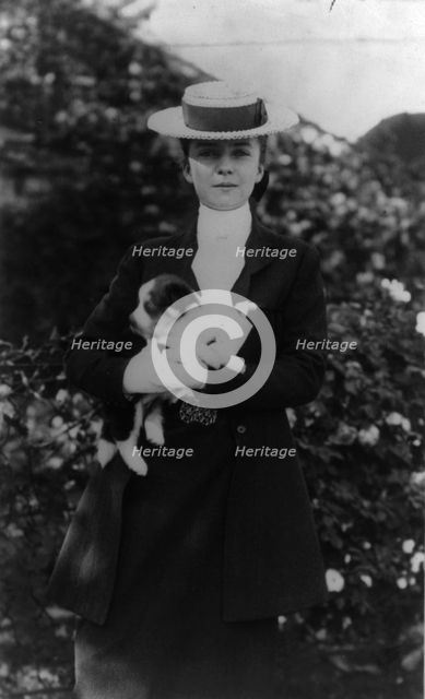 Alice Roosevelt in riding clothes, with dog, c1902 June 17. Creator: Frances Benjamin Johnston.