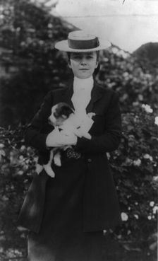 Alice Roosevelt in riding clothes, with dog, c1902 June 17. Creator: Frances Benjamin Johnston
