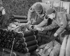 Allied Soldiers Loading Leaflets, Calling the Enemy to Surrender Into an Artillery Shell, 1943-1944. Creator: British Pathe Ltd