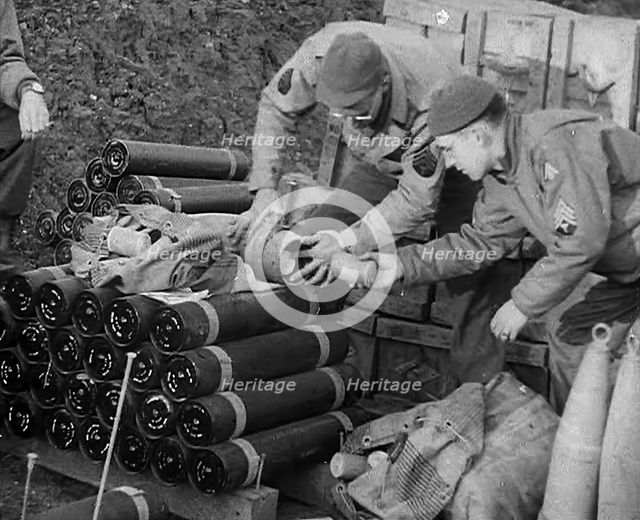 Allied Soldiers Loading Leaflets, Calling the Enemy to Surrender Into an Artillery Shell, 1943-1944. Creator: British Pathe Ltd.