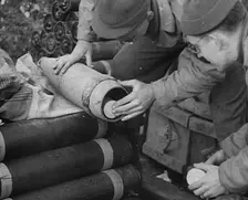Allied Soldiers Loading Leaflets, Calling the Enemy to Surrender Into an Artillery Shell, 1944. Creator: British Pathe Ltd