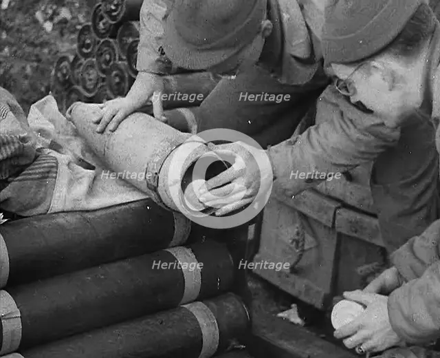 Allied Soldiers Loading Leaflets, Calling the Enemy to Surrender Into an Artillery Shell, 1944. Creator: British Pathe Ltd.