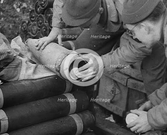 Allied Soldiers Loading Leaflets, Calling the Enemy to Surrender Into an Artillery Shell, 1944. Creator: British Pathe Ltd.