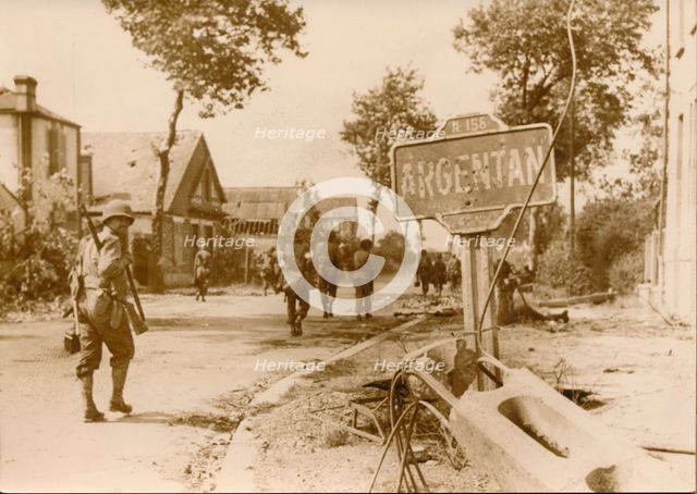 Allied troops moving throught the village of Argentan, France, 1944. Creator: Unknown.
