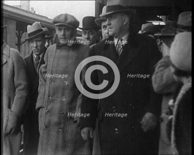 Alphonse Gabriel Capone AKA 'Al Capone' Being Escorted by a Group of Male American Civilians...1930. Creator: British Pathe Ltd.