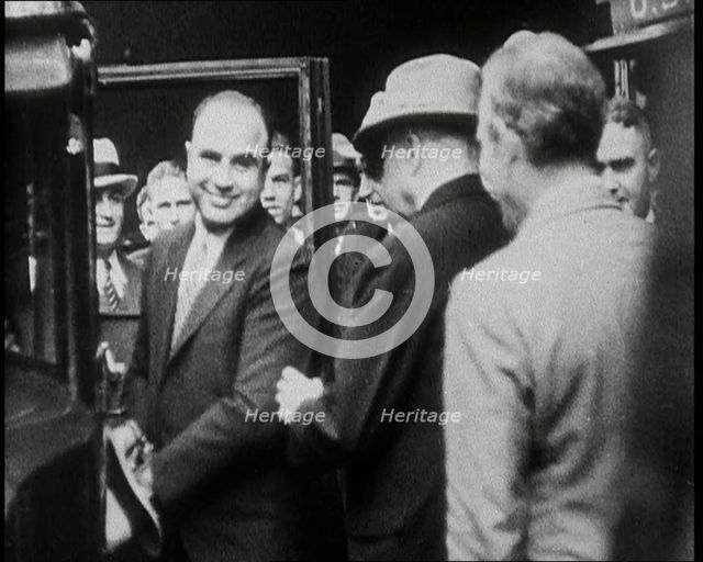 Alphonse Gabriel Capone AKA 'Al Capone' Entering a Car Watched by a Small Crowd, 1930. Creator: British Pathe Ltd.