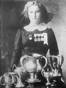 Alsie Aykroyd in front of her trophies, 1910. Creator: Bain News Service