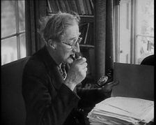 A.P. Herbert Inspecting Some Papers, 1930s. Creator: British Pathe Ltd