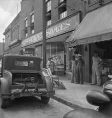 Appliqued embroideries for sale on street in front of ten cent..., Siler City, North Carolina, 1939. Creator: Dorothea Lange