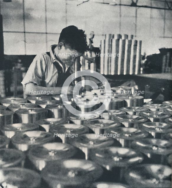 'Apprentice with microscope (testing the hardness of pistons)', 1941. Artist: Cecil Beaton.