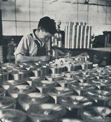 Apprentice with microscope (testing the hardness of pistons) 1941. Artist: Cecil Beaton