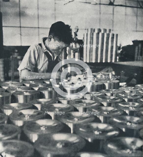 'Apprentice with microscope (testing the hardness of pistons)', 1941. Artist: Cecil Beaton.