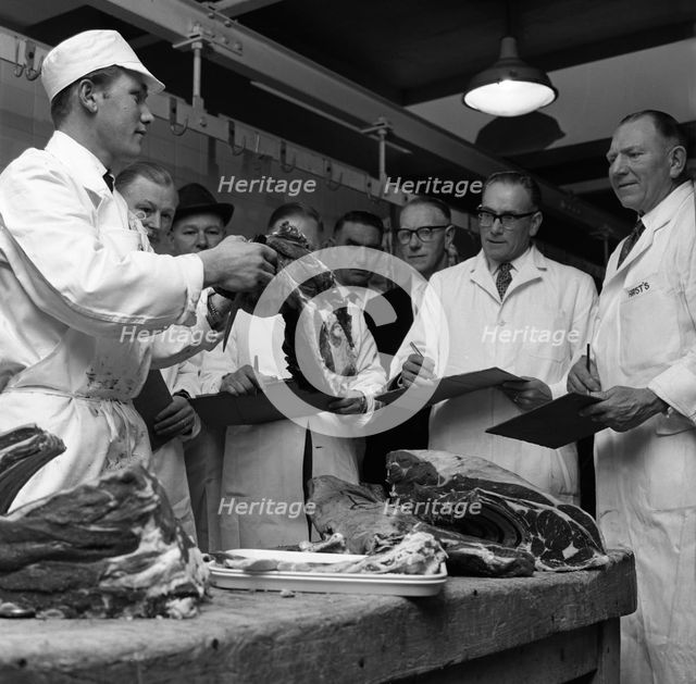 Apprentice butcher showing his work to competition judges, Barnsley, South Yorkshire, 1963. Artist: Michael Walters