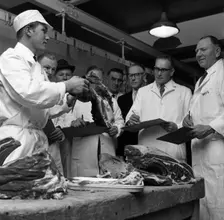 Apprentice butcher showing his work to competition judges, Barnsley, South Yorkshire, 1963. Creator: Michael Walters