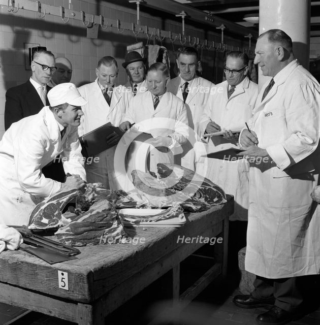 Apprentice butcher showing his work to competition judges, Barnsley, South Yorkshire, 1963. Artist: Michael Walters