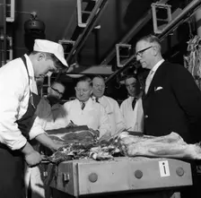 Apprentice butcher showing his work to competition judges, Barnsley, South Yorkshire, 1963. Creator: Michael Walters