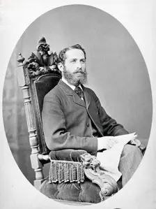 Arthur Schuster, seated, facing left, aged about 38, c1888. Creator: L Suscipj