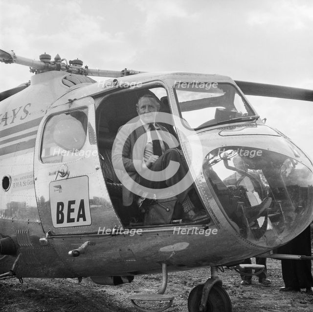 Artist Terence Cuneo in a BEA helicopter, London to Yorkshire Motorway, 10/1958. Creator: John Laing plc.