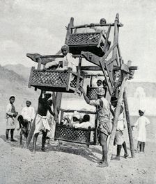 Arabian children enjoying a big-wheel 1922