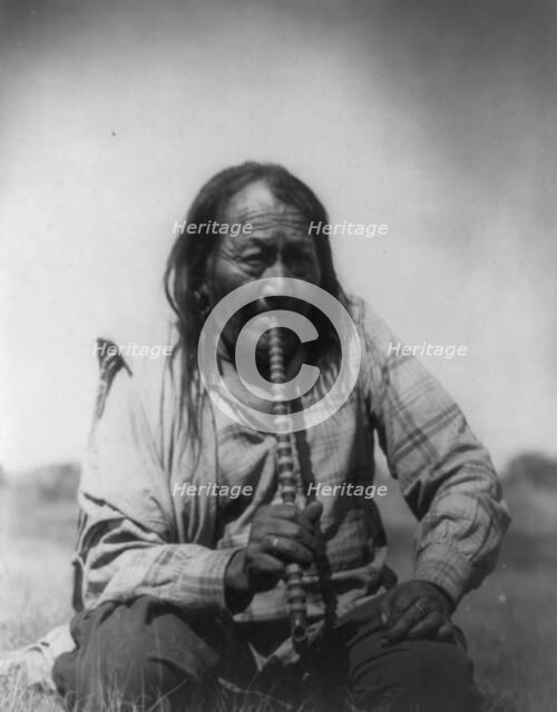 Arapaho Indian smoking pipe, c1910. Creator: Edward Sheriff Curtis.