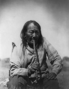Arapaho Indian smoking pipe, c1910. Creator: Edward Sheriff Curtis