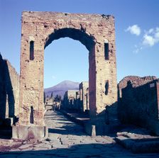 Arch of Caligula with Vesuvius beyond, Pompeii, Italy. Creator: Unknown