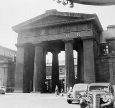 Arch outside the main entrance to Euston Station, Camden, London, 1952. Creator: Henry Grant